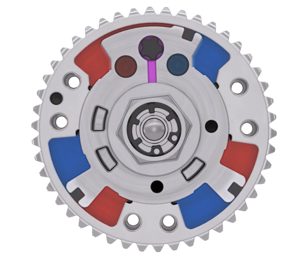 A metallic gear features a central hexagonal structure, surrounded by colored segments in red, blue, and gray, with additional holes and design details